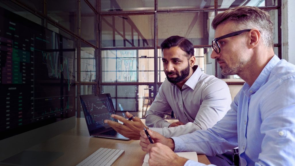 Image of colleagues looking at data on a screen